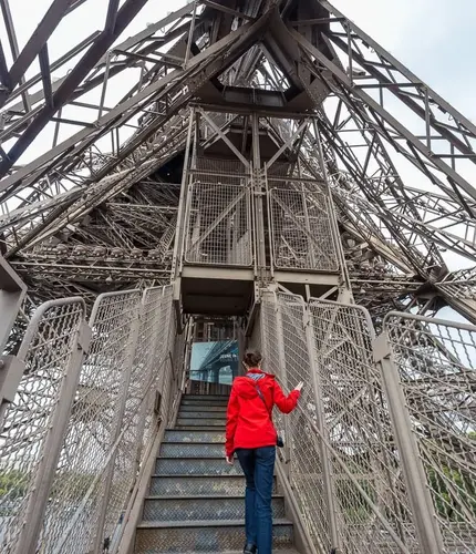 A woman climbing the stairs of the Eiffel Tower