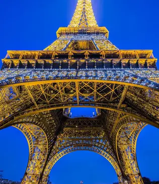 View from below the Eiffel Tower at night